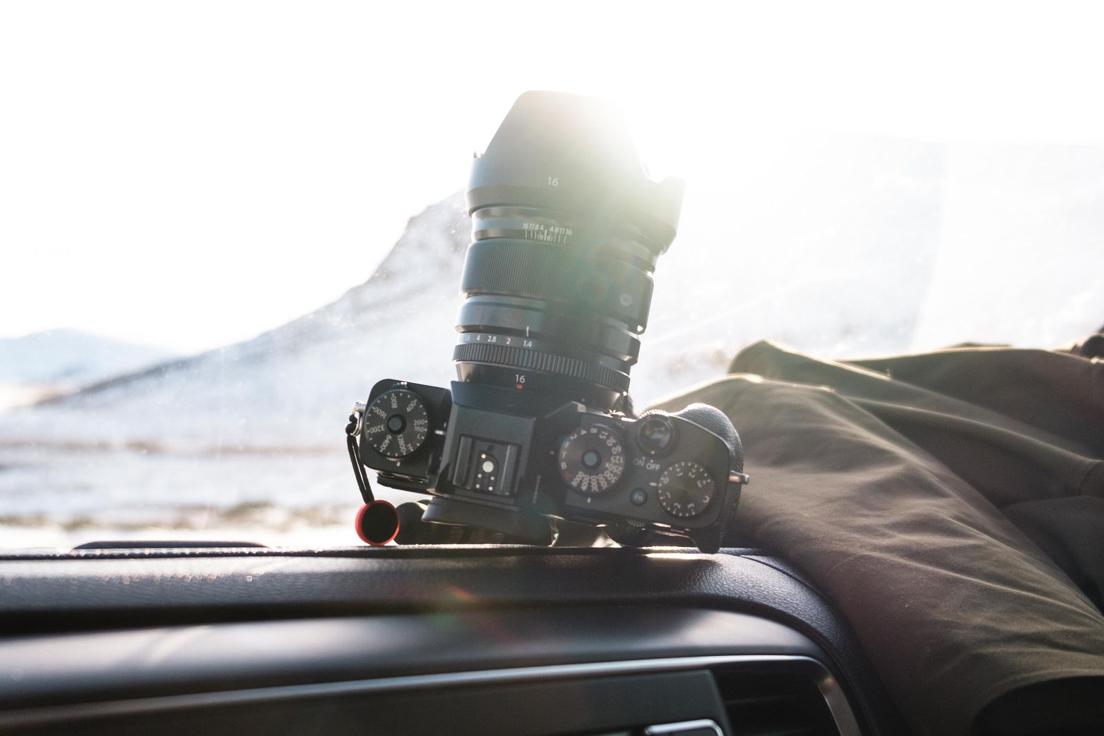 A compact camera mounted on a car dashboard facing the road ahead