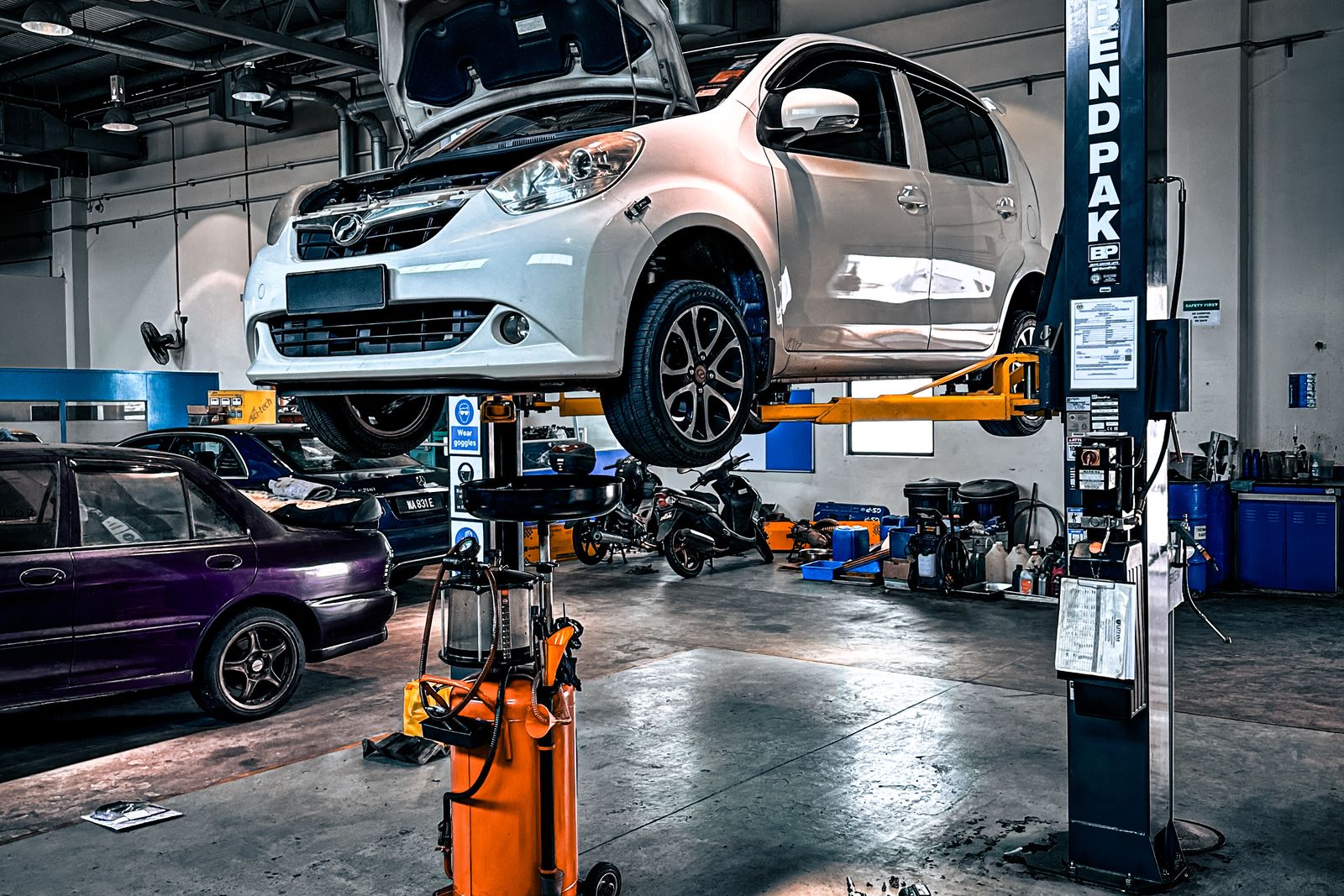 A mechanic working on a vehicle during routine maintenance