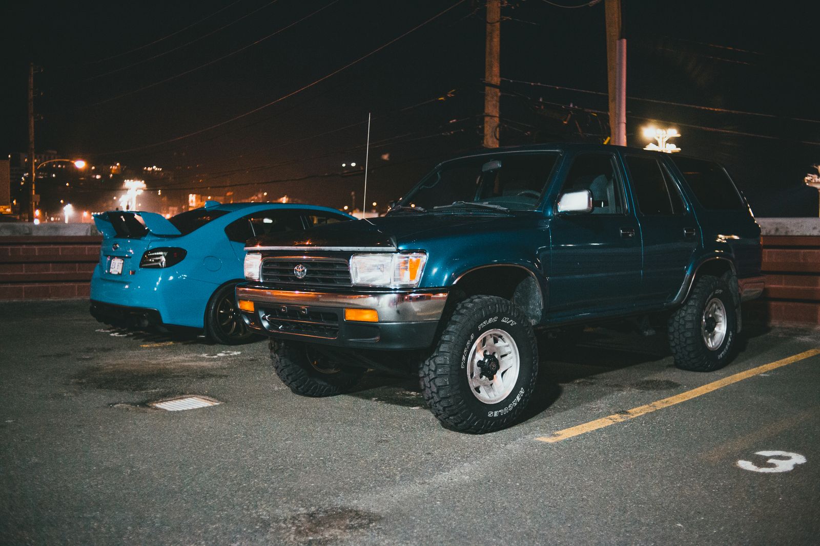 A new and a used vehicle parked side by side for comparison